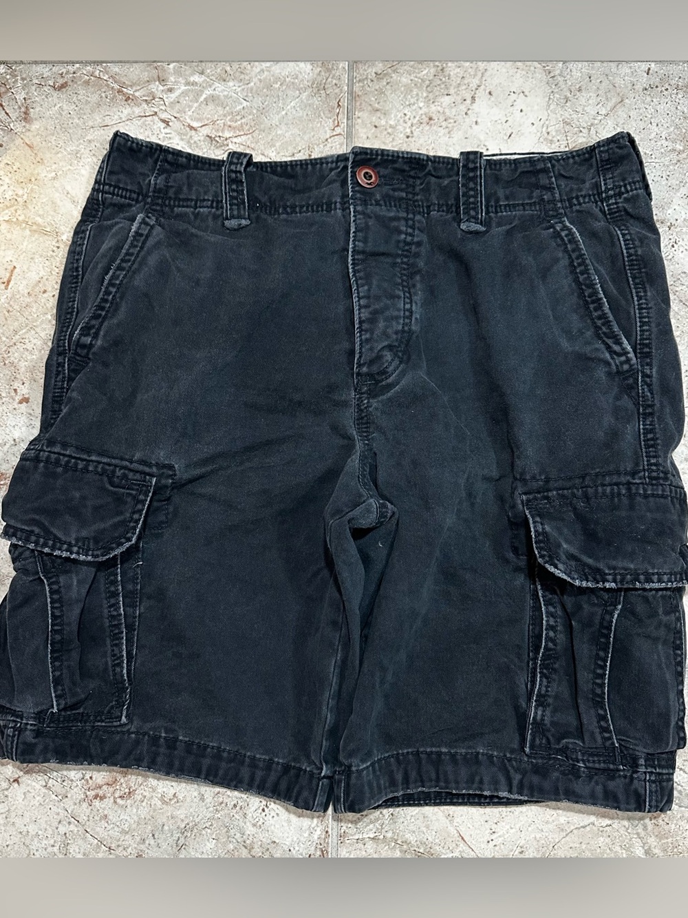 Vintage Hollister Co. black cargo shorts in a baggy, wide-leg fit, size 34.